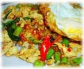 fried meat with basil leaves